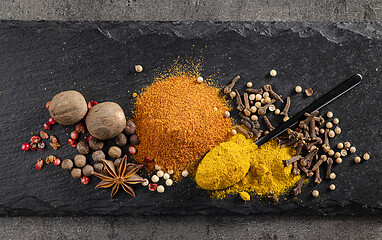 Image showing various spices on black plate