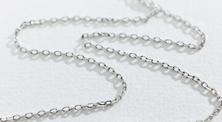 Image showing silver chain on white paper background