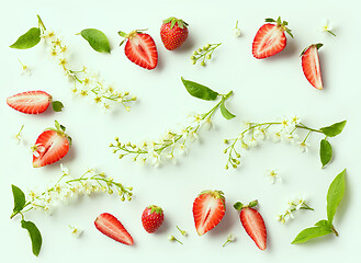 Image showing blooming bird cherry and strawberries