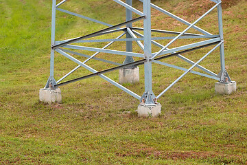 Image showing Lower part of a large electric support on a background of green 