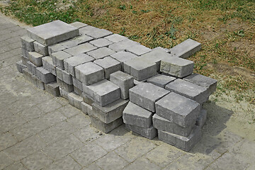 Image showing Pile of gray paving slabs stacked on the roadside