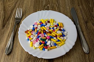 Image showing A bunch of pills on a plate