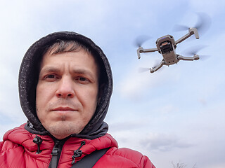 Image showing Man controls flying drone