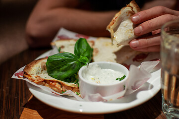 Image showing Man eating delicious quesadilla in restaurant