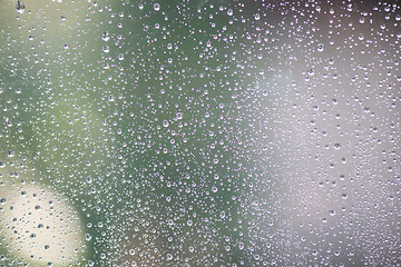 Image showing Drops of rain on window with abstract lights