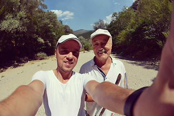 Image showing dad and son taking selfie photos