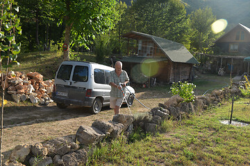 Image showing gardener watering the plants