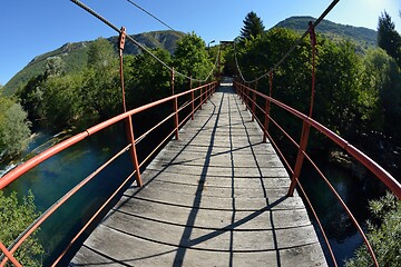 Image showing wooden bridge over wild river