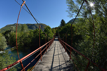 Image showing wooden bridge over wild river