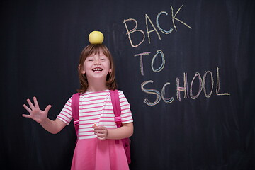 Image showing child holding apple on head