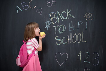 Image showing happy child with apple and back to school drawing in background