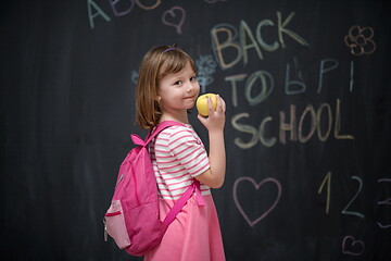 Image showing happy child with apple and back to school drawing in background