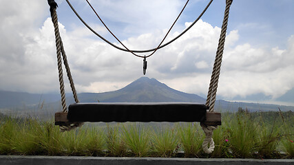 Image showing Wooden swing on the rope with view of Batur volcano