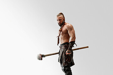 Image showing Man in leather viking\'s costume isolated on white studio background