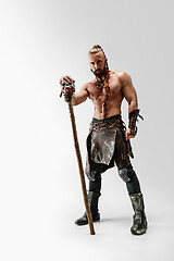 Image showing Man in leather viking\'s costume isolated on white studio background