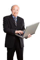 Image showing Senior asian businessman and laptop