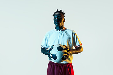 Image showing Male soccer player standing with the ball isolated on white background