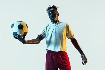 Image showing Male soccer player standing with the ball isolated on white background