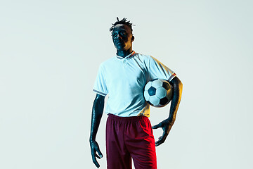 Image showing Male soccer player standing with the ball isolated on white background