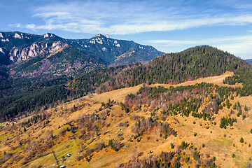 Image showing Autumn pasture and rocky mountain behind