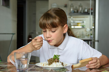 Image showing Girl eats the second dish for lunch