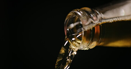 Image showing Beer being poured against dark background with slow movements