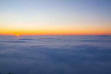 Image showing Amazing sunrise above clouds from the top of the mountain 