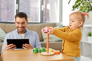 Image showing father with tablet pc and baby daughter at home