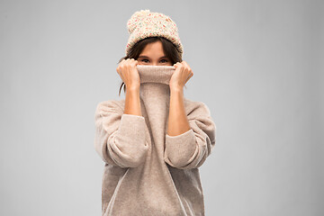 Image showing young woman in knitted winter sweater and hat