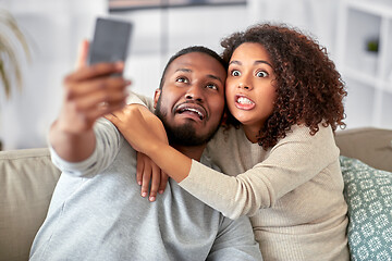 Image showing couple with smartphone taking selfie at home