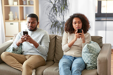 Image showing african american couple with smartphone at home