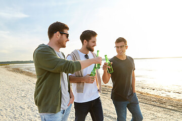 Image showing young men toasting non alcoholic beer on beach