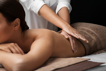 Image showing woman lying and having back massage at spa