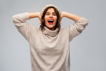 Image showing young woman in knitted winter hat and sweater