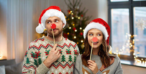 Image showing couple with christmas party props in ugly sweaters