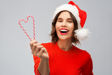 Image showing happy young woman in santa hat on christmas