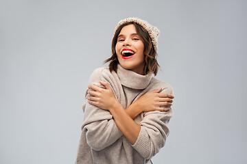 Image showing young woman in knitted winter hat and sweater