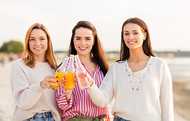 Image showing young women toasting non alcoholic drinks on beach