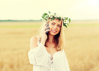 Image showing happy young woman calling on smartphone at country