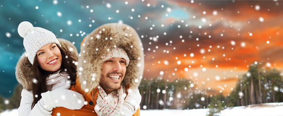 Image showing happy couple having fun over winter background