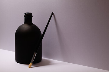 Image showing Still life with luxury black glass of Rrum and paintbrush 