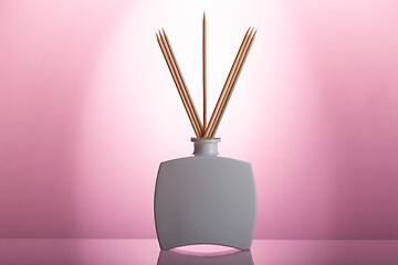 Image showing Aromatic reed air freshener on the glass table 