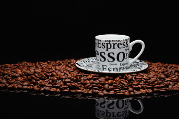 Image showing Coffee mug on a pile of coffee beans 