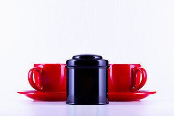 Image showing Two red cups of tea and black box on the tea 