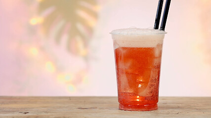 Image showing fresh pink soft drink in plastic take away cup 