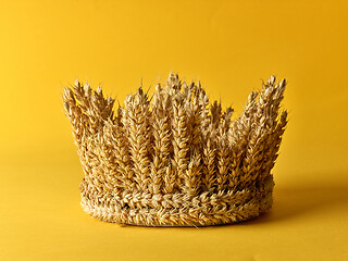 Image showing crown made of wheat ears of cereals on a yellow background