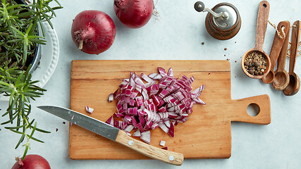 Image showing chopped red onions on wooden cutting board