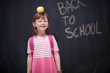 Image showing child holding apple on head