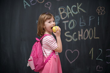 Image showing happy child with apple and back to school drawing in background