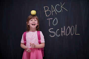 Image showing child holding apple on head